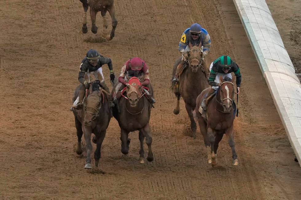 Brian Hernandez Jr. rides Mystik Dan, right, across the finish line to win the 150th running of ...