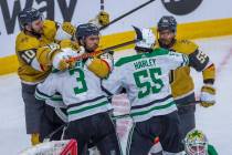 Golden Knights left wing William Carrier (28) fights with Dallas Stars defenseman Chris Tanev ( ...
