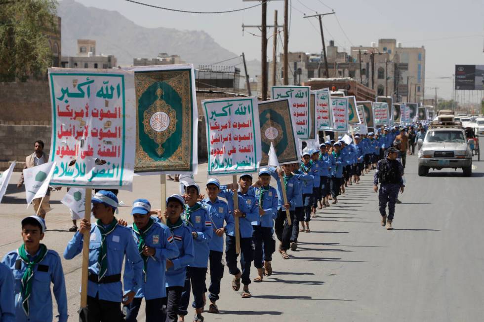 Yemeni students carry anti-Israel and anti-U.S. banners during a march organized by Houthis, to ...