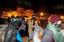 Pro-Palestinian demonstrators remove belongings from an encampment after police arrived on the ...