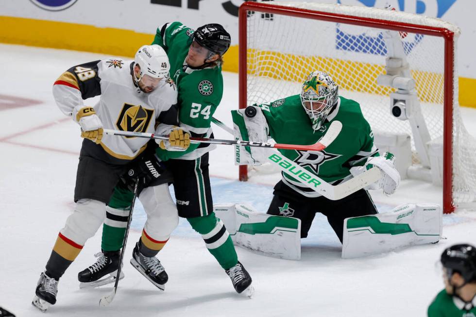 Dallas Stars goaltender Jake Oettinger, right, blocks a shot as teammate Roope Hintz (24) defen ...