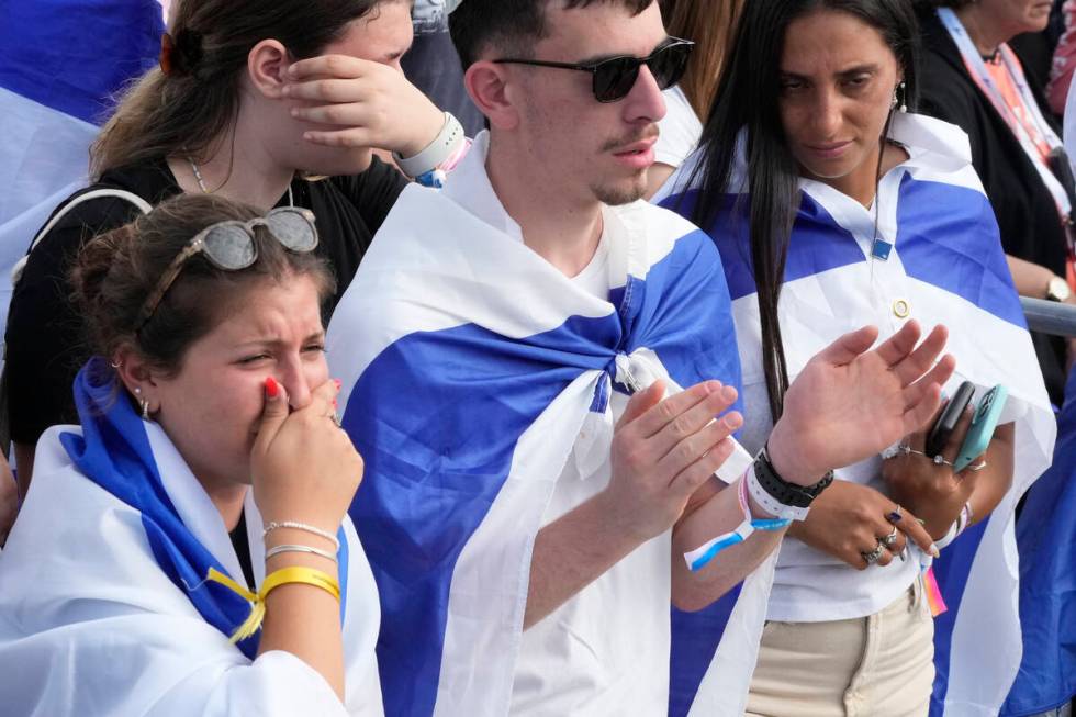 People attend a ceremony at the former Nazi German death camp of Auschwitz-Birkenau during the ...