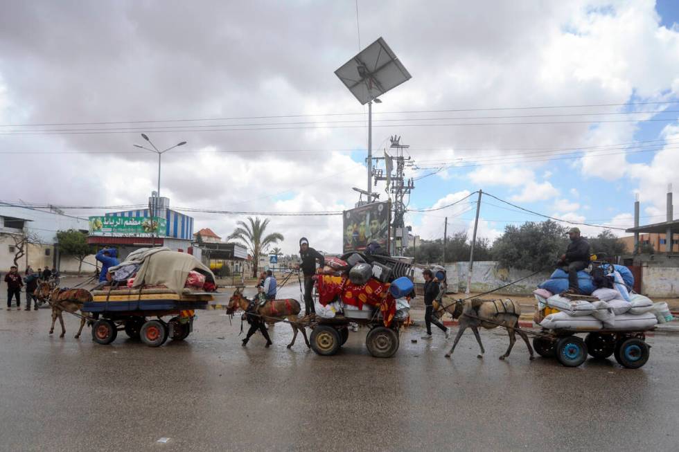 Palestinians flee from the eastern side of the southern Gaza city of Rafah after the Israeli ar ...