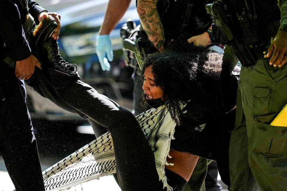 Authorities detain a protester on the campus of Emory University during a pro-Palestinian demon ...