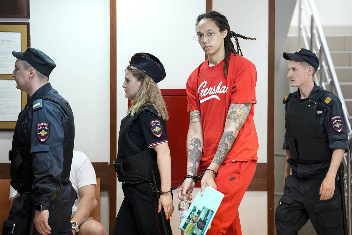 FILE - WNBA star and two-time Olympic gold medalist Brittney Griner, second from right, is esco ...