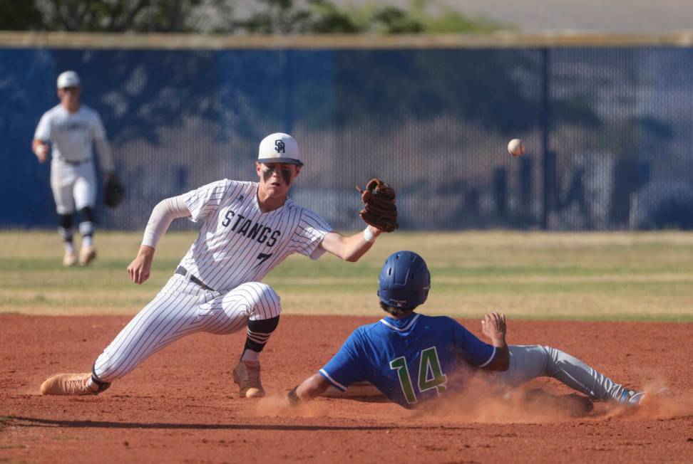 Shadow Ridge's Brock Morrow (7) misses the ball as Green Valley's Isaiah Alba (14) gets to seco ...