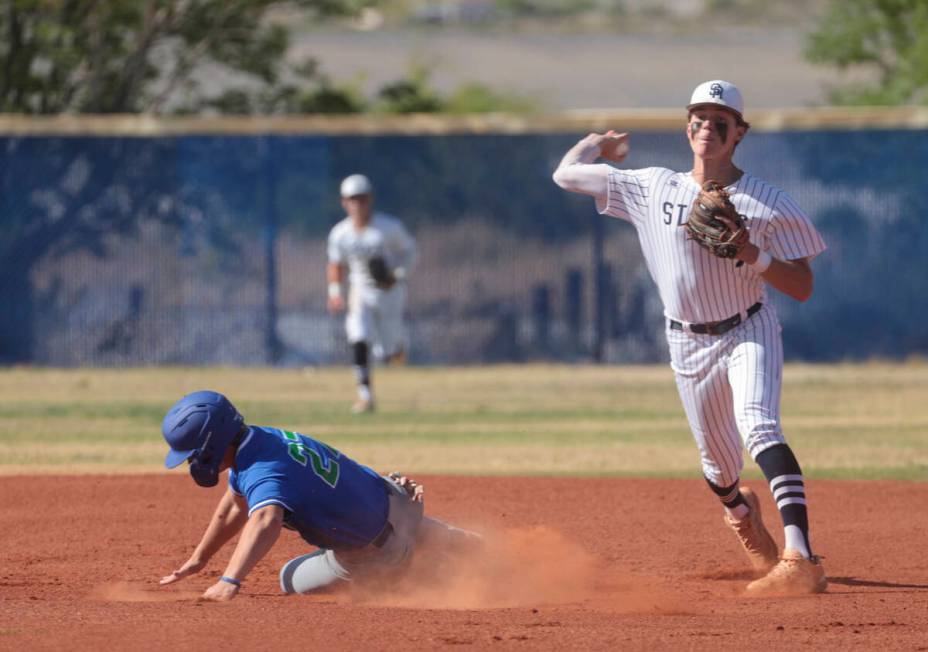 Shadow Ridge's Brock Morrow, right, throws to first base after tagging out Green Valley's Brand ...