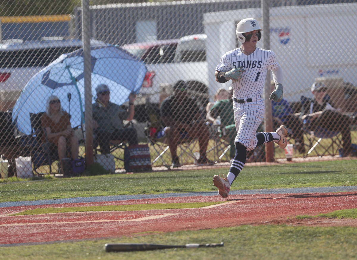 Shadow Ridge's Evan Noble (1) scores a run against Green Valley during a high school NIAA playo ...