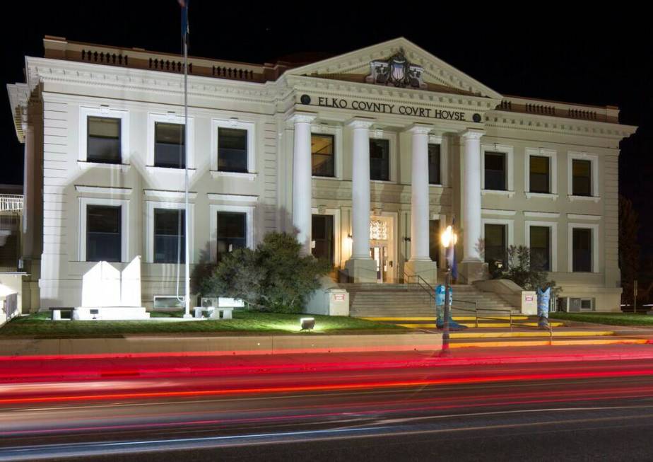 Cars leave trails of light as they pass the Elko County Court House in Elko on Friday, Oct. 19, ...