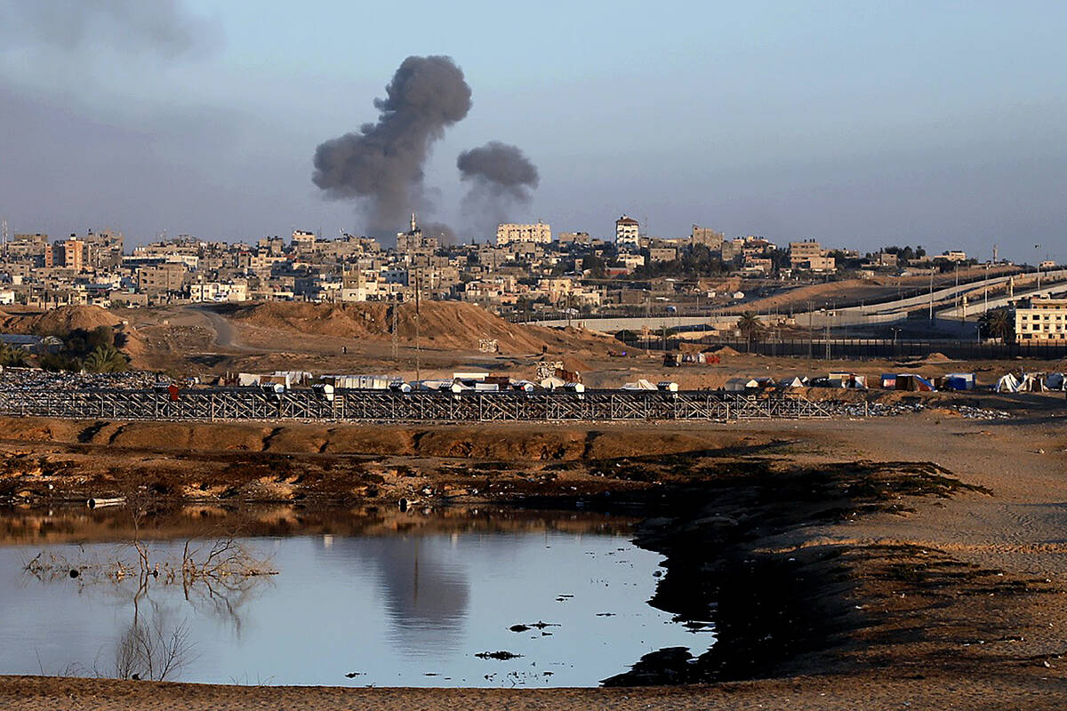 Smoke rises following an Israeli airstrike on buildings near the separating wall between Egypt ...