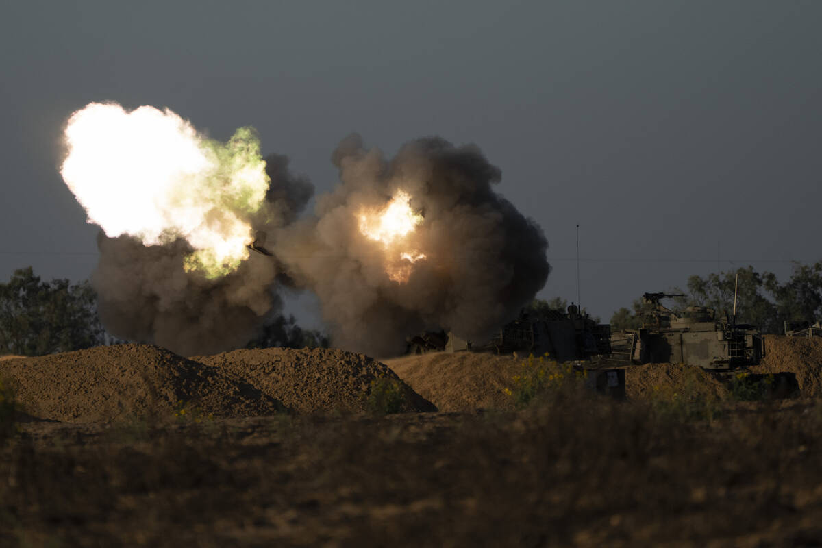 An Israeli mobile artillery unit fires a shell from southern Israel towards the Gaza Strip, in ...