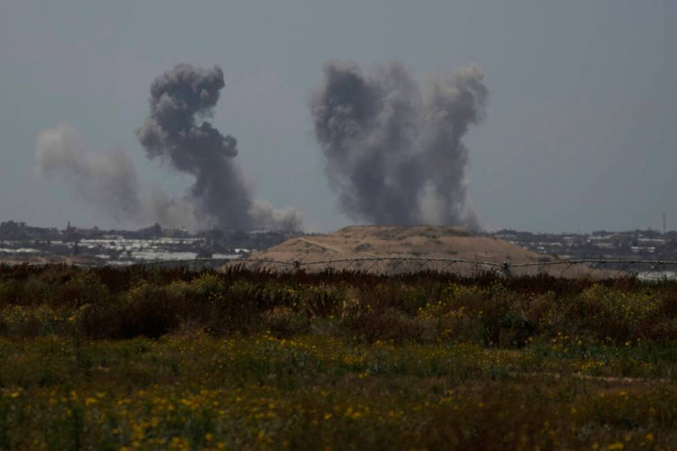 Smoke rises following an Israeli bombardment in the Gaza Strip as seen from southern Israel, Tu ...