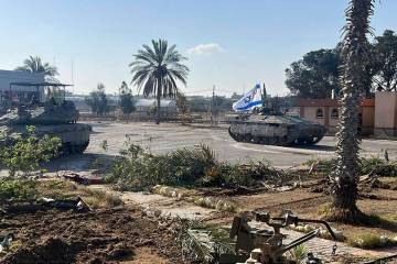 This photo provided by the Israel Defense Forces shows a tank with an Israel flag on it enterin ...