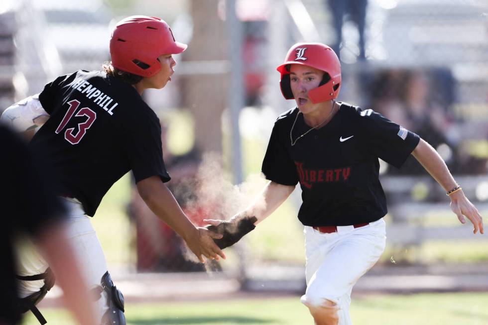 Liberty's Chris Onoszko (1) high fives his teammate Christopher Hemphill (13) after scoring dur ...