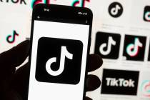 The TikTok logo is displayed on a mobile phone in front of a computer screen, Oct. 14, 2022, in ...