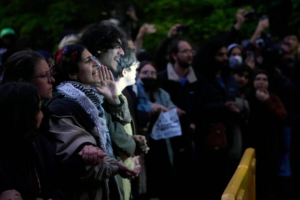 Pro-Palestinian protesters chat as police kept them away from the university's quad while the s ...