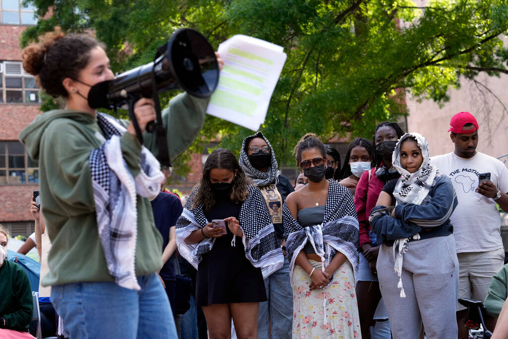 Demonstrators listen during a mock trial on the campus of George Washington University in Washi ...