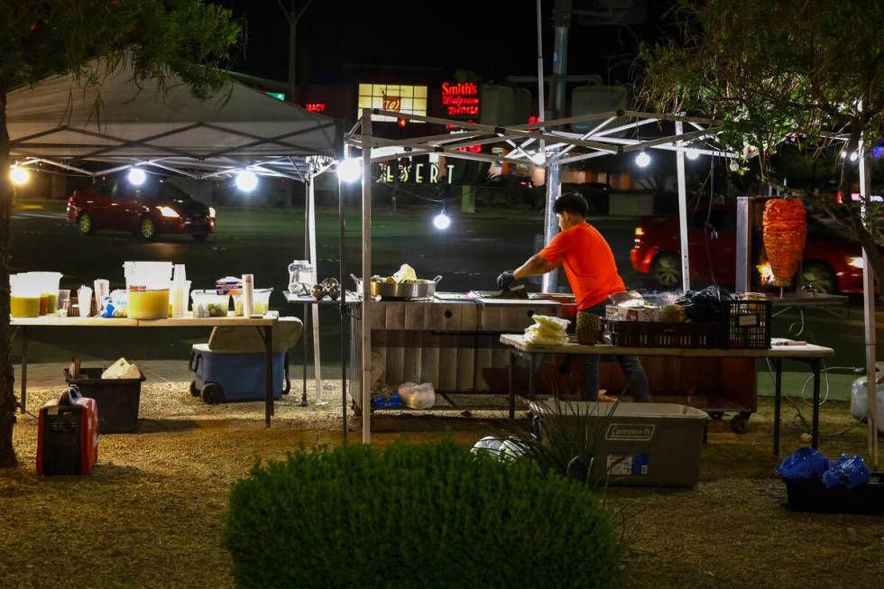 Jaime Melendez works at his taco stand at the corner of Durango Drive and Warm Springs Road, on ...