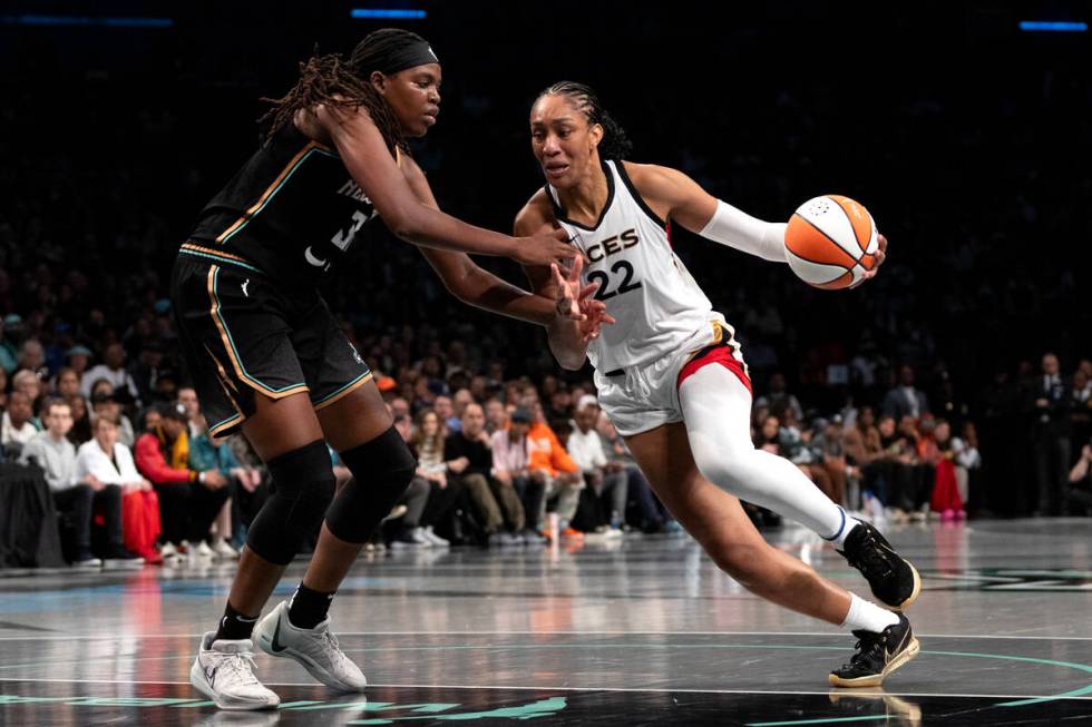 Las Vegas Aces forward A'ja Wilson (22) drives around New York Liberty forward Jonquel Jones (3 ...