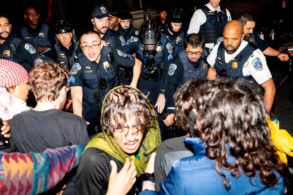 Demonstrators clash with the Metropolitan Police Department officers at George Washington Unive ...