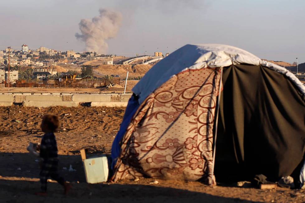 Smoke rises following an Israeli airstrike on buildings near the separating wall between Egypt ...