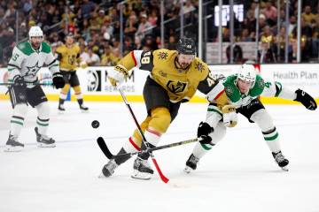 Golden Knights center Tomas Hertl (48) attempts to break away with the puck while Stars defense ...