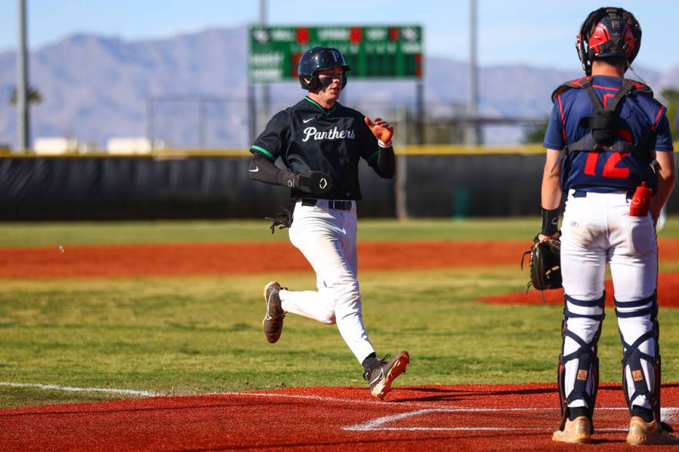 Palo Verde’s Drew Kaplan (15) runs safely to home plate while Coronado catcher AJ Stalteri (1 ...