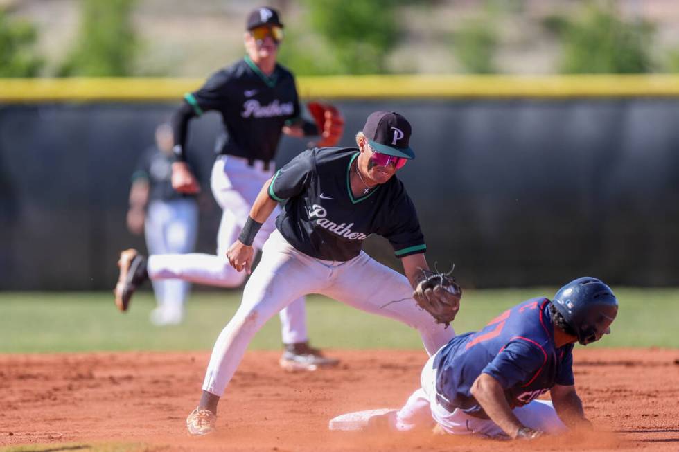 Palo Verde infielder Ethan Clauss, center, reaches to tag out Coronado’s Michael Cortez ...