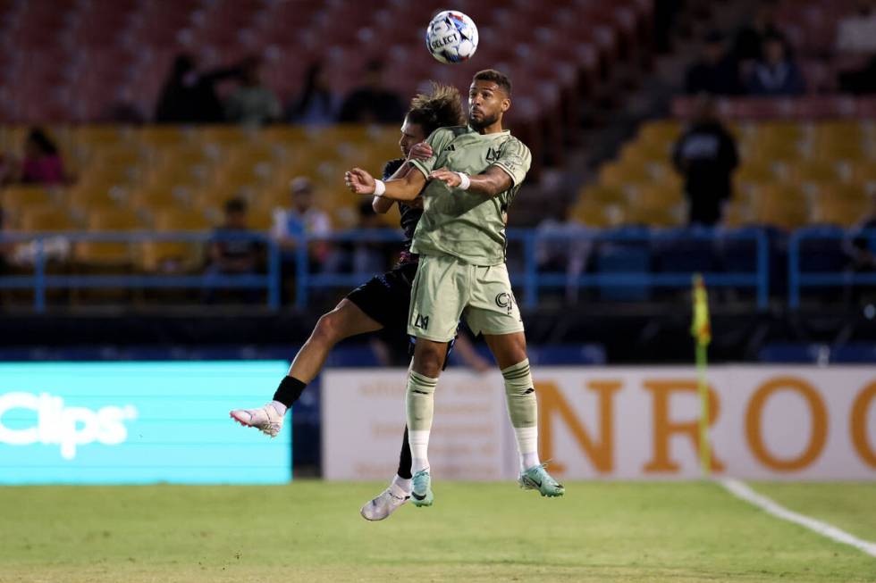 Las Vegas Lights FC Gennaro Nigro (33) and Los Angeles FC forward Denis Bouanga (99) jump for a ...