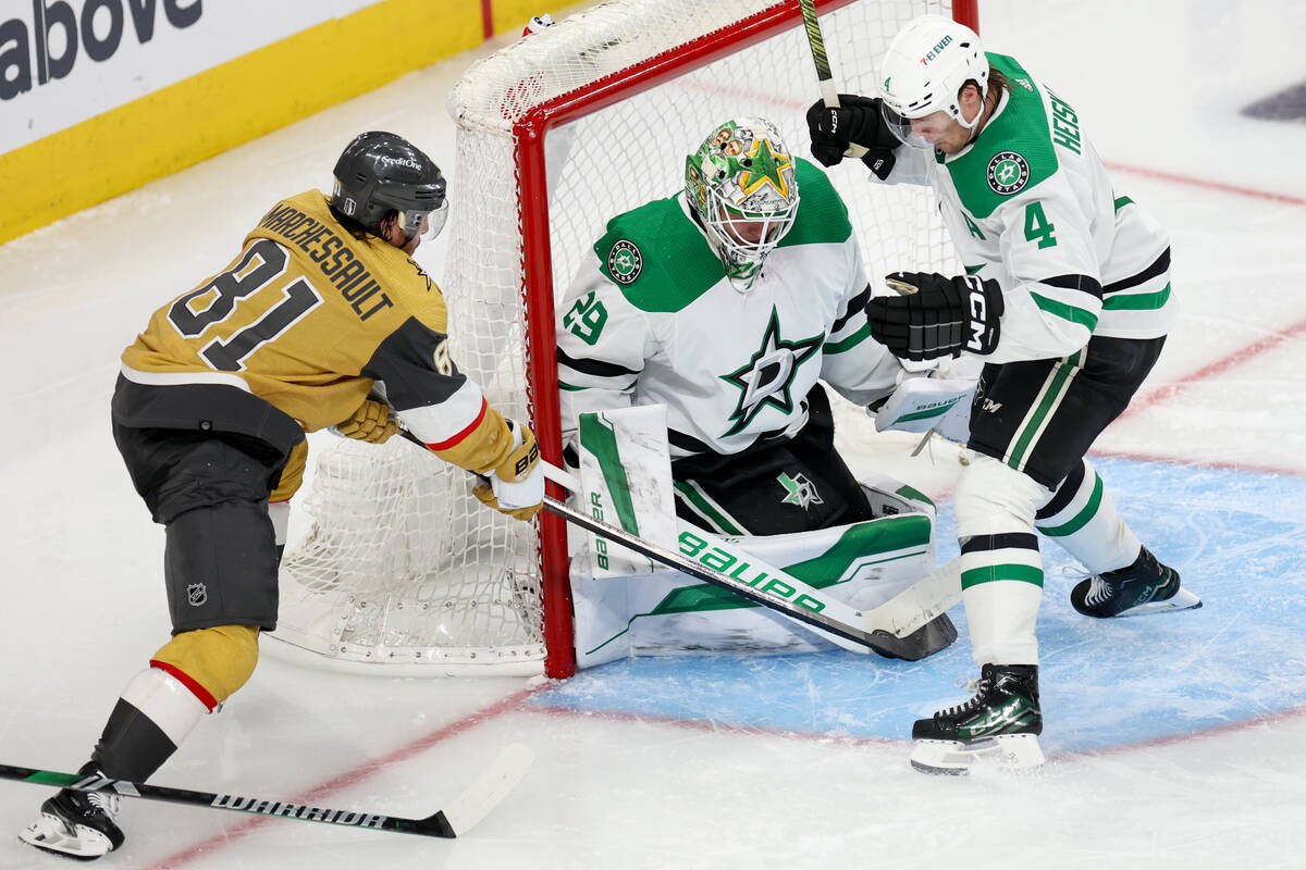 Stars goaltender Jake Oettinger (29) and defenseman Miro Heiskanen (4) thwart a shot on goal by ...