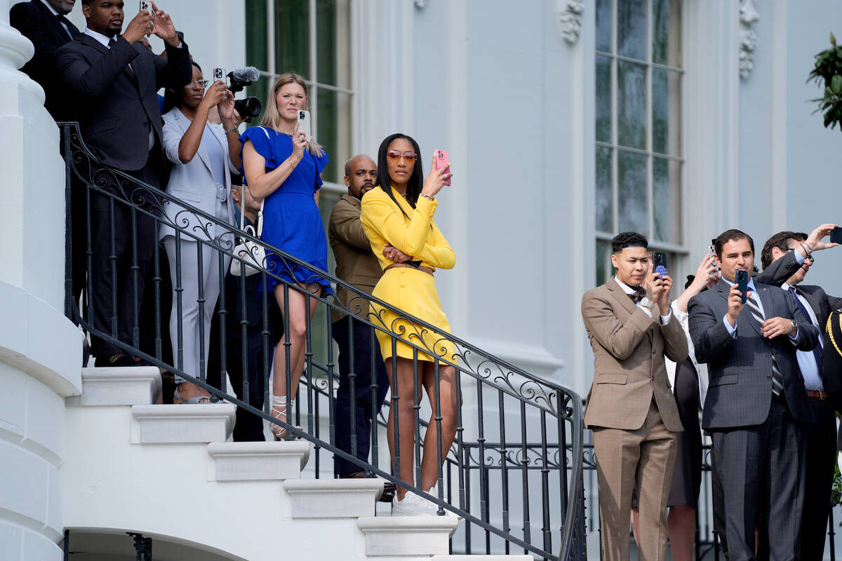 A'ja Wilson, of the 2023 WNBA champion Las Vegas Aces, center, waits to watch President Joe Bid ...