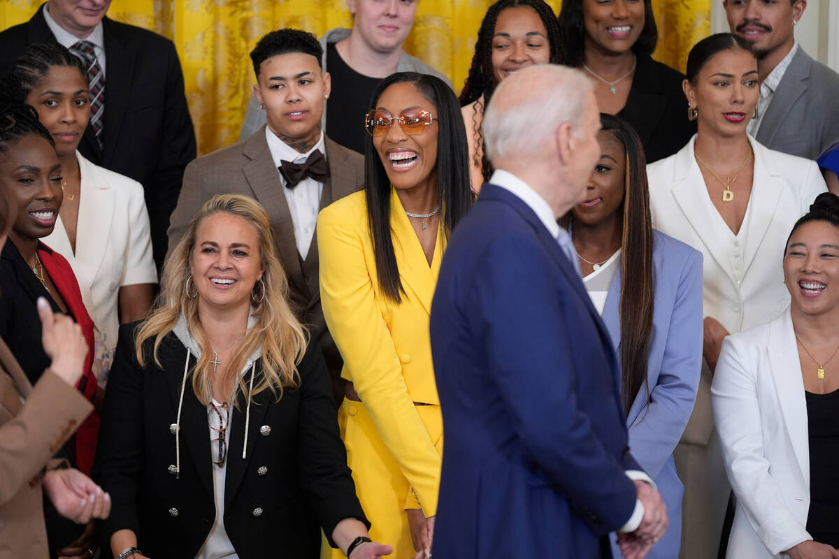 A'ja Wilson, center, of the WNBA's Las Vegas Aces, laughs as President Joe Biden, in foreground ...