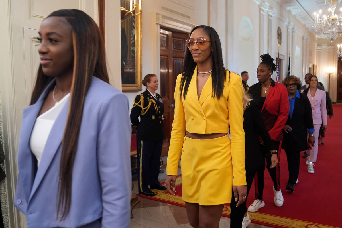 A'ja Wilson, of the 2023 WNBA champion Las Vegas Aces, second from left, arrives at an event wi ...