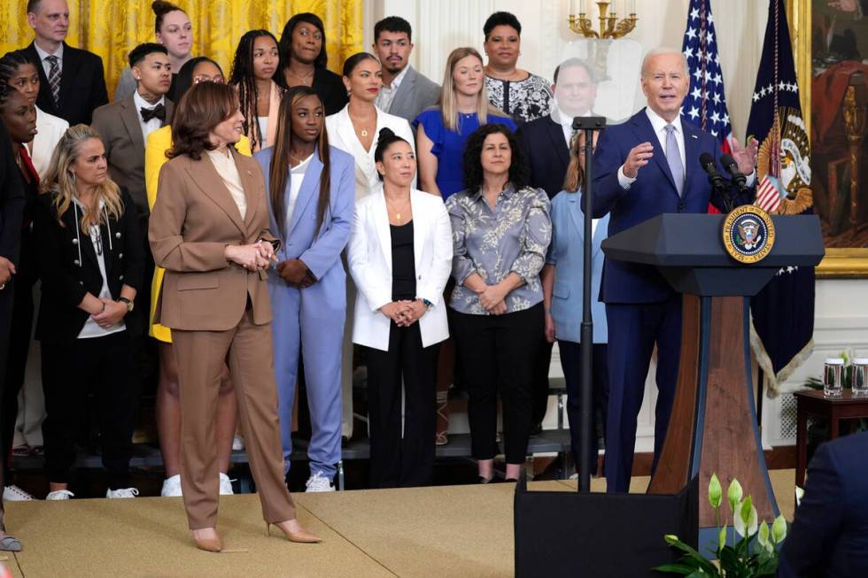 President Joe Biden speaks as Vice President Kamala Harris, left, listens during an event to ce ...