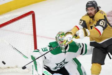 Golden Knights right wing Mark Stone (61) reaches for the puck after Stars goaltender Jake Oett ...