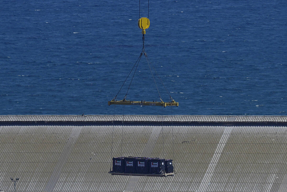 A lift loads food aid for Gaza on the container ship Sagamore at Larnaca port, Cyprus, on Wedne ...