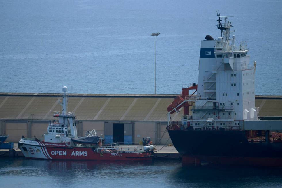 A view of the open arms ship and the container ship Sagamore, right, docked at Larnaca port, Cy ...