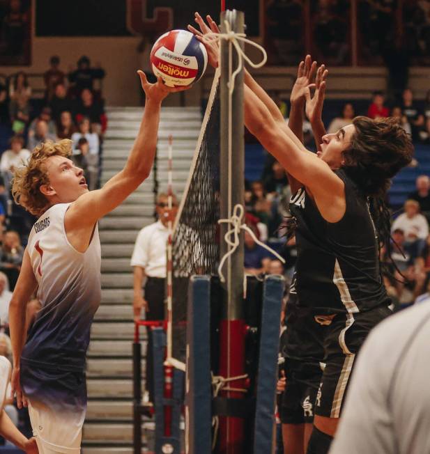 Coronado setter Braxton Rowley (1) tips the ball over the net during a Class 5A high school boy ...