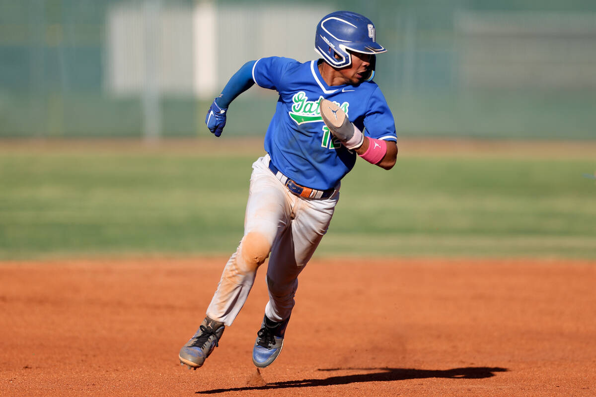 Green Valley infielder Caden Kirby (12) sprints to third before being outed by Coronado during ...