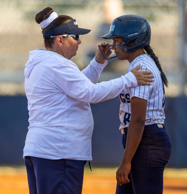 Shadow Ridge head coach Julia Meyn helps batter Jimena Barraza (8) to stay focused against Coro ...