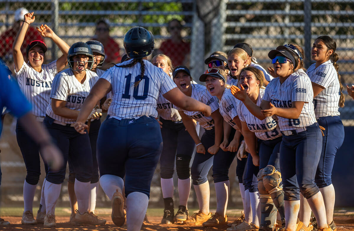 Shadow Ridge batter Abby Covington (10) is celebrated at home plater after a two-run homer agai ...
