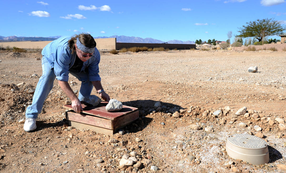 Howard Johnson checks the irrigation system he installed at his unfinished subdivision in the s ...