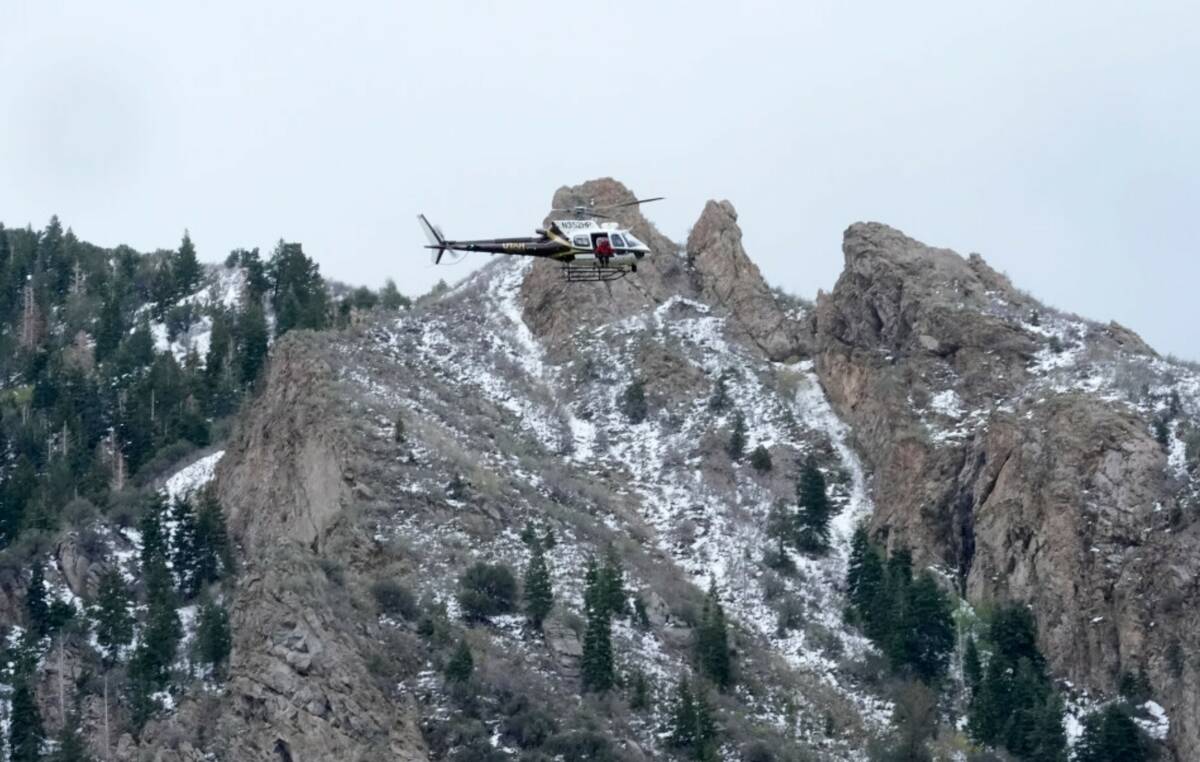 A Utah Department of Public Safety helicopter carries rescuers from Hidden Valley Park on Thurs ...