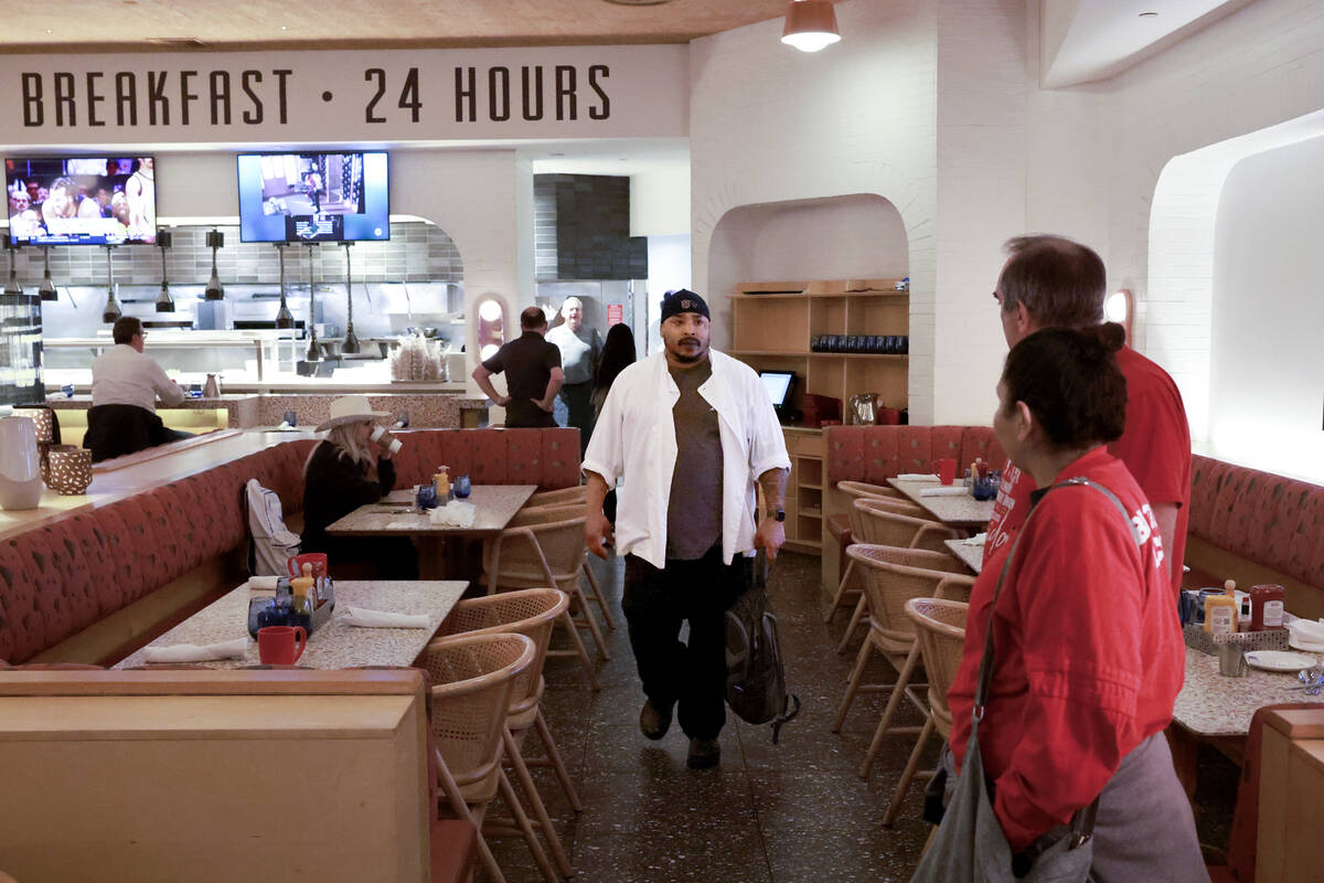 Union officials watch as a member walks off the job just after 5 a.m. at the start of a Culinar ...