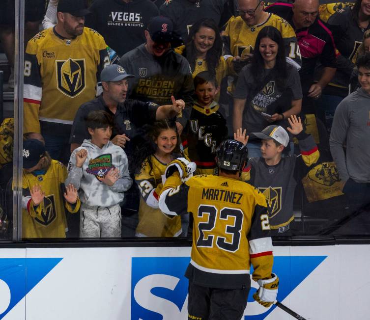 Golden Knights defenseman Alec Martinez (23) greets fans before the first period of their NHL p ...