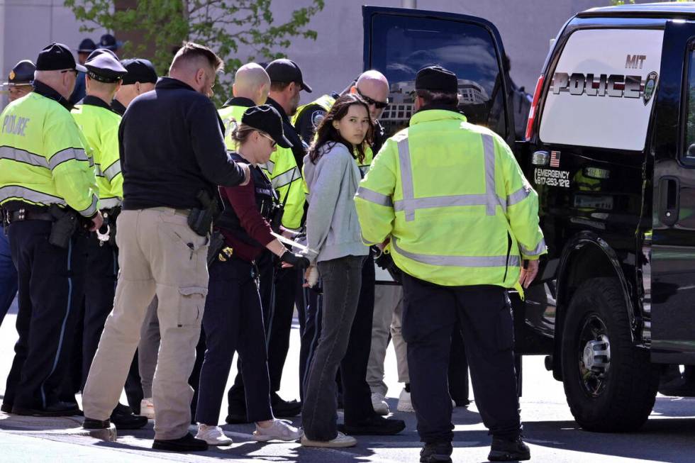 Police detain a pro-Palestinian demonstrator who attempted to block traffic from the garage of ...