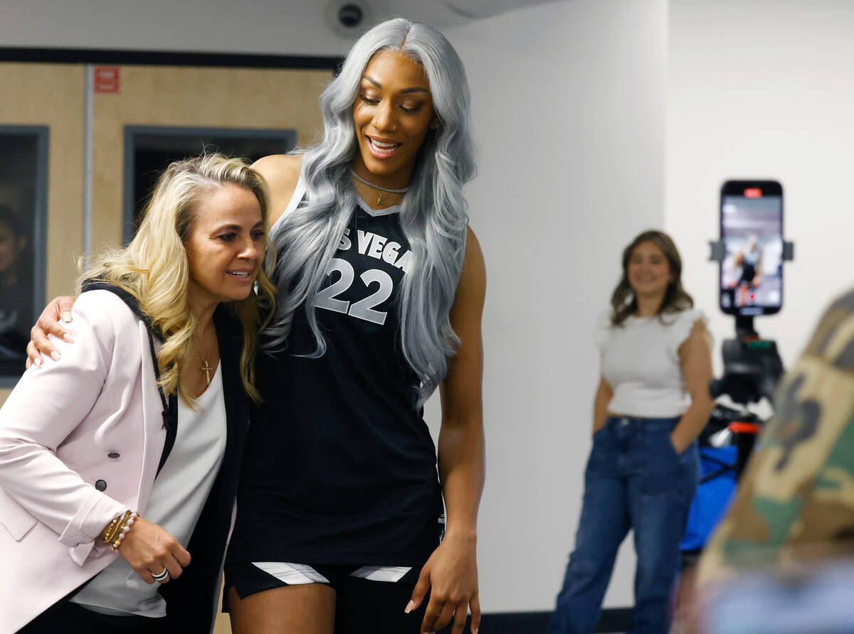 Las Vegas Aces head coach Becky Hammon, left, and center A'ja Wilson (22) greet each other duri ...