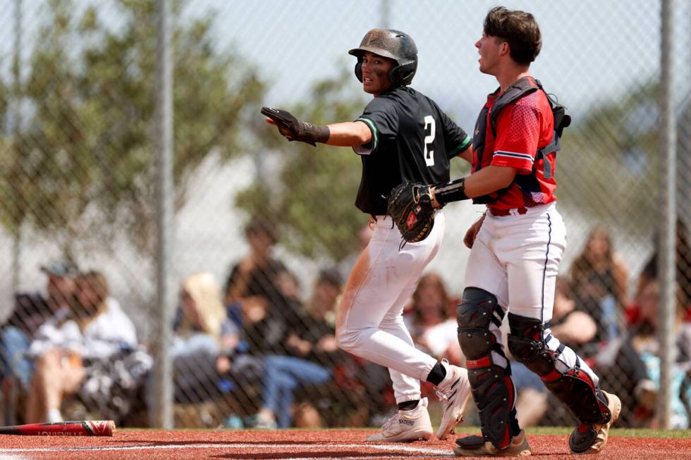 Palo Verde infielder Luke Herrera (2) scores at home plate while Coronado catcher A.J. Salteri ...