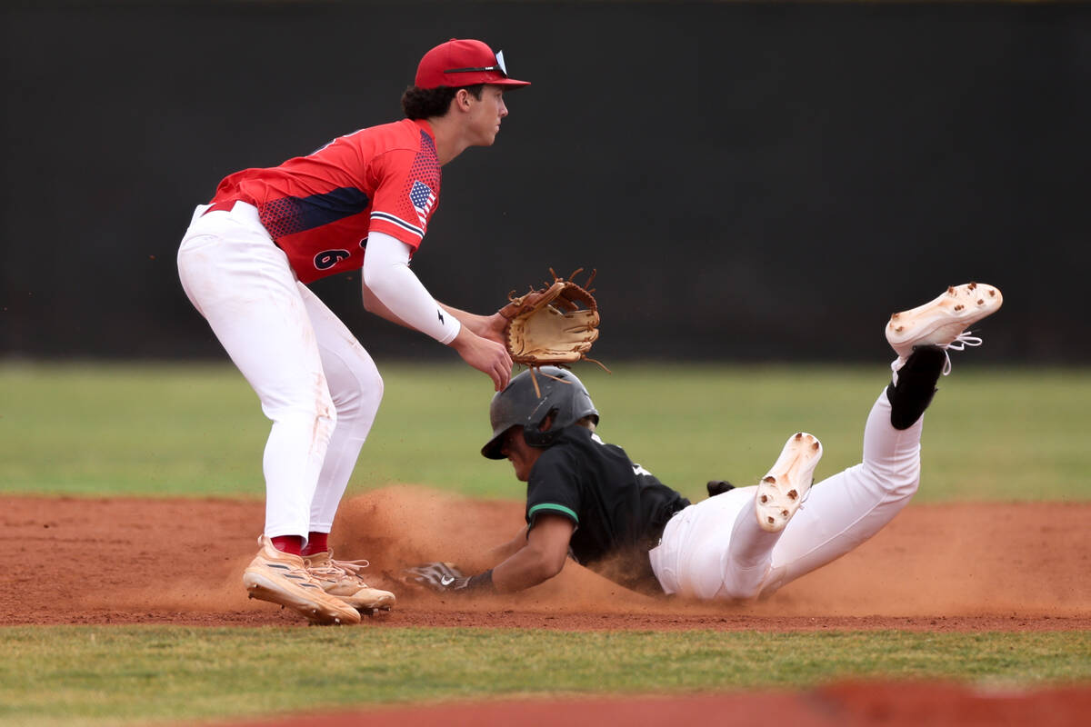 Palo Verde’s Luke Herrera slides safely into second base while Coronado’s Louis D ...