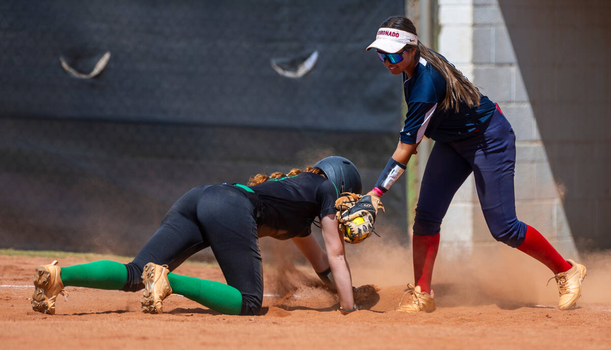 Palo Verde infielder Mya Bartlett (18) dives back to first base safely against Coronado infield ...